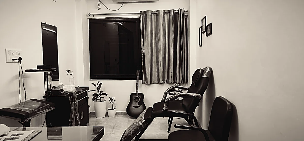 Inside the Link2Ink studio in Gandhinagar — the tattoo chair, sterile workstation and framed studio mantras.
